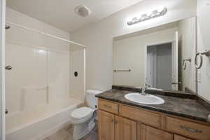 Bathroom featuring vanity, shower / washtub combination, and light tile patterned floors