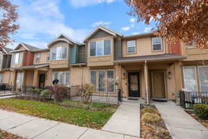 Traditional-style home with stucco siding and covered porch
