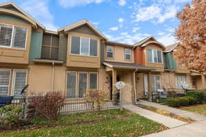 View of front of home featuring stucco siding and a porch