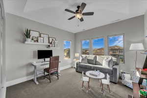 Home office featuring carpet flooring and ceiling fan