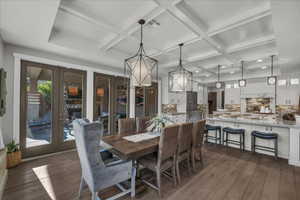 Dining space with dark wood-type flooring, french doors, coffered ceiling, and beamed ceiling