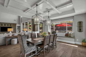 Dining room featuring coffered ceiling, hardwood / wood-style flooring, and beamed ceiling