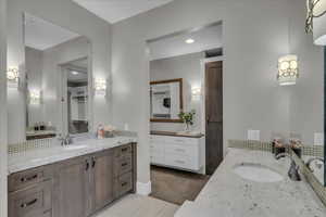 Full bath with two vanities, light tile patterned flooring, recessed lighting, and light colored carpet