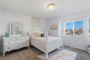 Bedroom with carpet flooring and baseboards