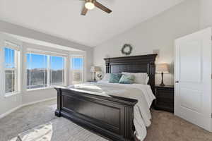 Bedroom featuring lofted ceiling, carpet, and ceiling fan