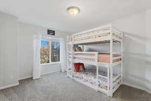 Carpeted bedroom with baseboards