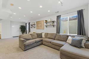 Living room featuring light carpet and recessed lighting