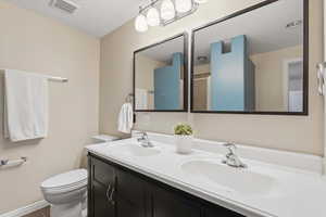 Bathroom with double vanity and toilet