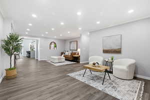 Living area featuring ornamental molding, recessed lighting, and wood finished floors