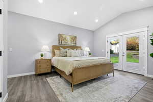 Bedroom with lofted ceiling, french doors, access to exterior, recessed lighting, and wood finished floors