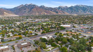Aerial overview of property's location with a mountainous background and nearby suburban area