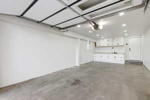 Garage with recessed lighting and a garage door opener