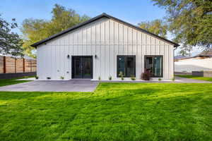 Back of house featuring board and batten siding and french doors
