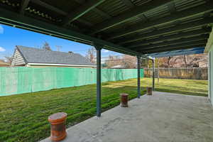 Fenced backyard with a patio area