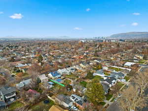 Aerial overview of property's location featuring mountains and nearby suburban area