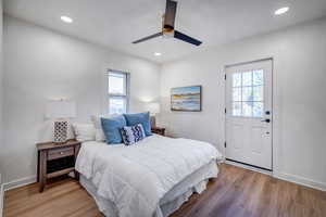 Bedroom featuring light wood-style flooring, ceiling fan, and recessed lighting