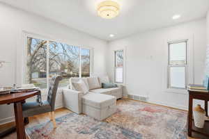 Living area featuring wood finished floors and recessed lighting