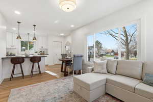 Living area featuring light wood-type flooring and recessed lighting