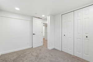 Unfurnished bedroom with carpet flooring, recessed lighting, and a closet