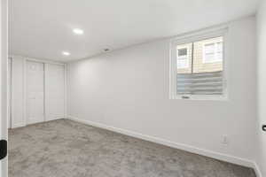 Unfurnished bedroom with carpet floors, a closet, and recessed lighting