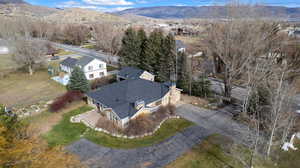 Aerial view of property's location featuring mountains