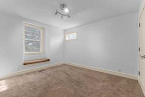 Unfurnished room with carpet floors and baseboards