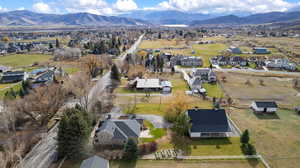 Aerial view of property's location featuring nearby suburban area and a mountain backdrop