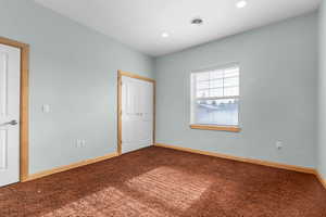 Unfurnished bedroom with carpet and a closet