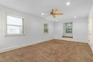 Empty room with recessed lighting, light colored carpet, and a ceiling fan