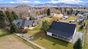 Aerial overview of property's location featuring a mountain backdrop and nearby suburban area