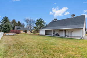 Back of house featuring roof with shingles