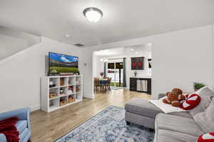 Living area featuring a chandelier and light wood finished floors