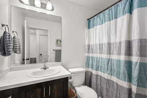 Full bathroom featuring a shower with curtain and vanity