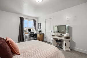 Bedroom featuring light carpet and baseboards
