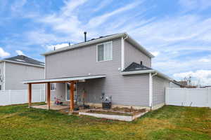 Back of property with a fenced backyard, a patio, and a gate