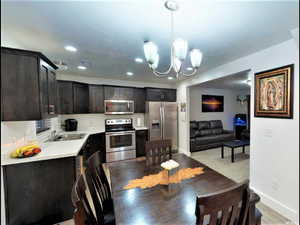 Dining space with a chandelier, recessed lighting, and light wood finished floors
