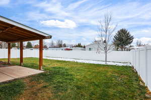 Fenced backyard with a patio