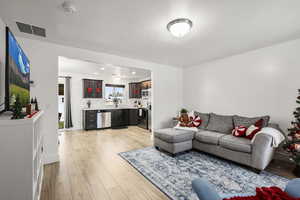Living room with light wood finished floors and baseboards