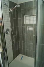 Full bath featuring a shower stall