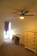 Carpeted office space featuring baseboards and ceiling fan