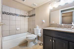 Bathroom with tub / shower combination, vanity, light tile patterned flooring, and a textured ceiling