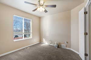 Spare room with carpet flooring and ceiling fan