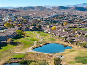 Aerial perspective of suburban area with a golf course and a water and mountain view