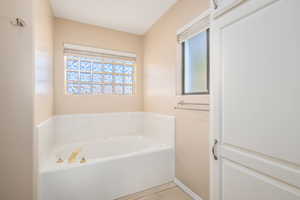 Full bath featuring a bath and plenty of natural light