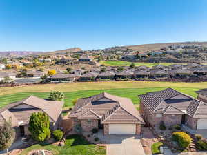 Aerial perspective of suburban area with a golf club and mountains