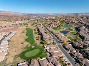 Aerial view of property's location featuring nearby suburban area and a water and mountain view