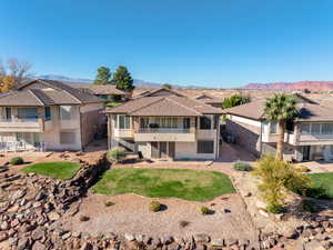 Rear view of property with a balcony, a patio area, a mountain view, and stucco siding