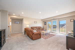 Living area featuring light carpet and recessed lighting