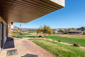 View of grassy yard featuring a patio area and view of golf course