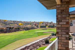 View of community with a residential view, a balcony, a yard, and golf course view
